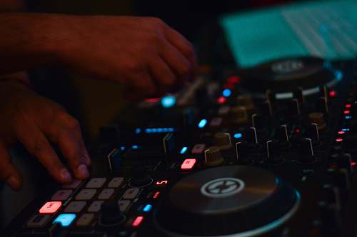 computer hardware person using DJ controller hardware